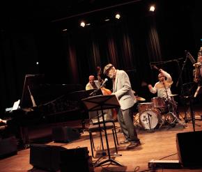 Poet Amiri Baraka performing with a group of jazz musicians on a stage