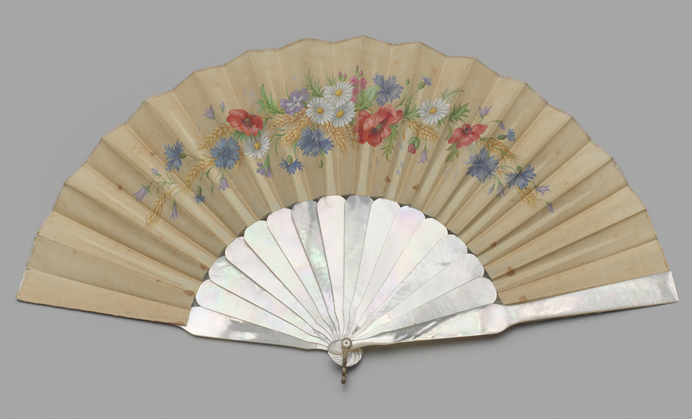 A museum photo of a folding fan of painted chicken skin between 1886-1889.