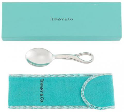 Small sterling silver spoon with wide mouth and looped handle with original flannel bag and box in signature color of Tiffany and Company.