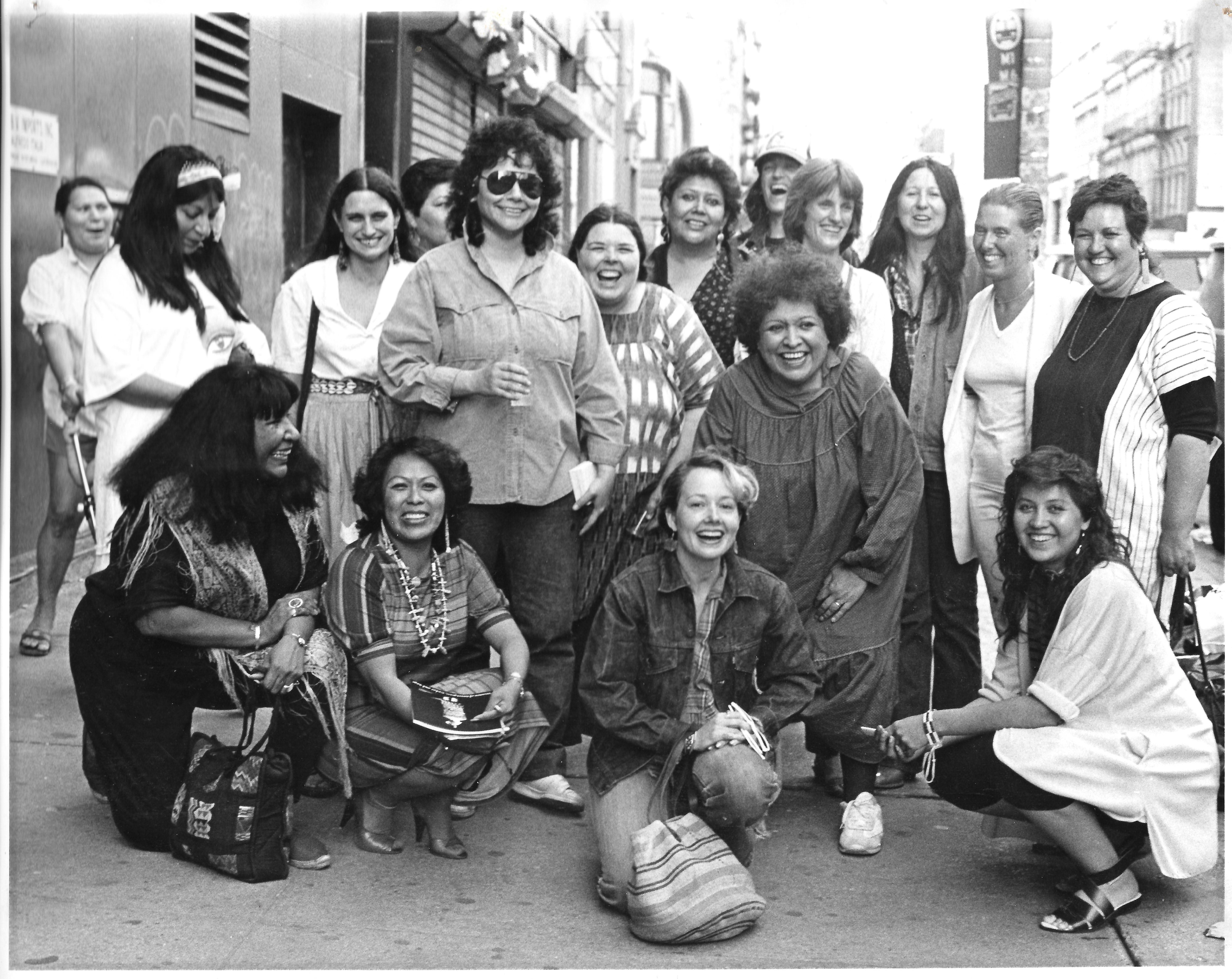 1) Artists from the exhibition, Women of Sweetgrass, Cedar and Sage, friends and community members outside the American Indian Community House Gallery, 1985.
