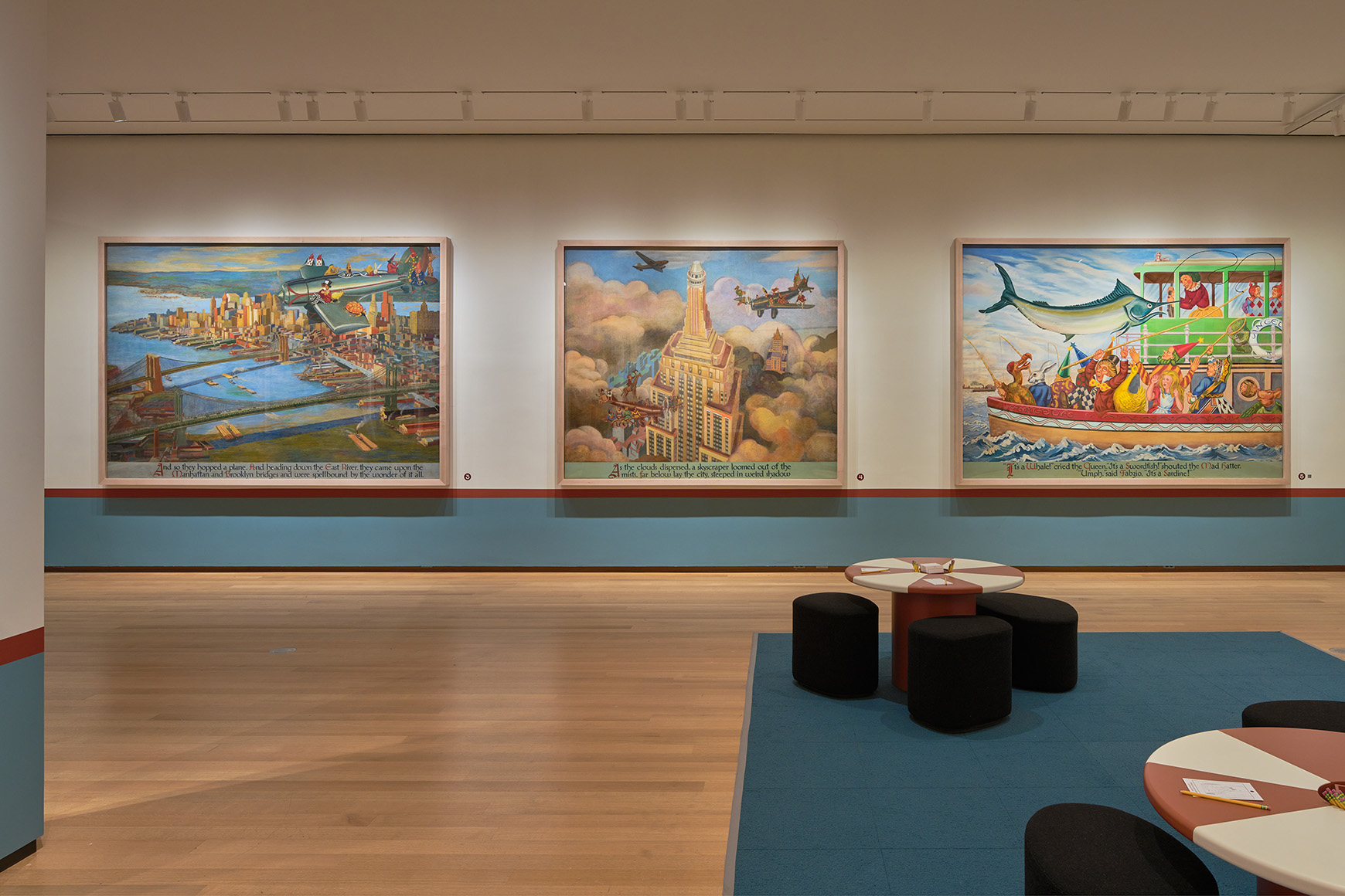 Large mural panels showing Alice and other characters exploring New York City, with red and white tables in the middle of the gallery.