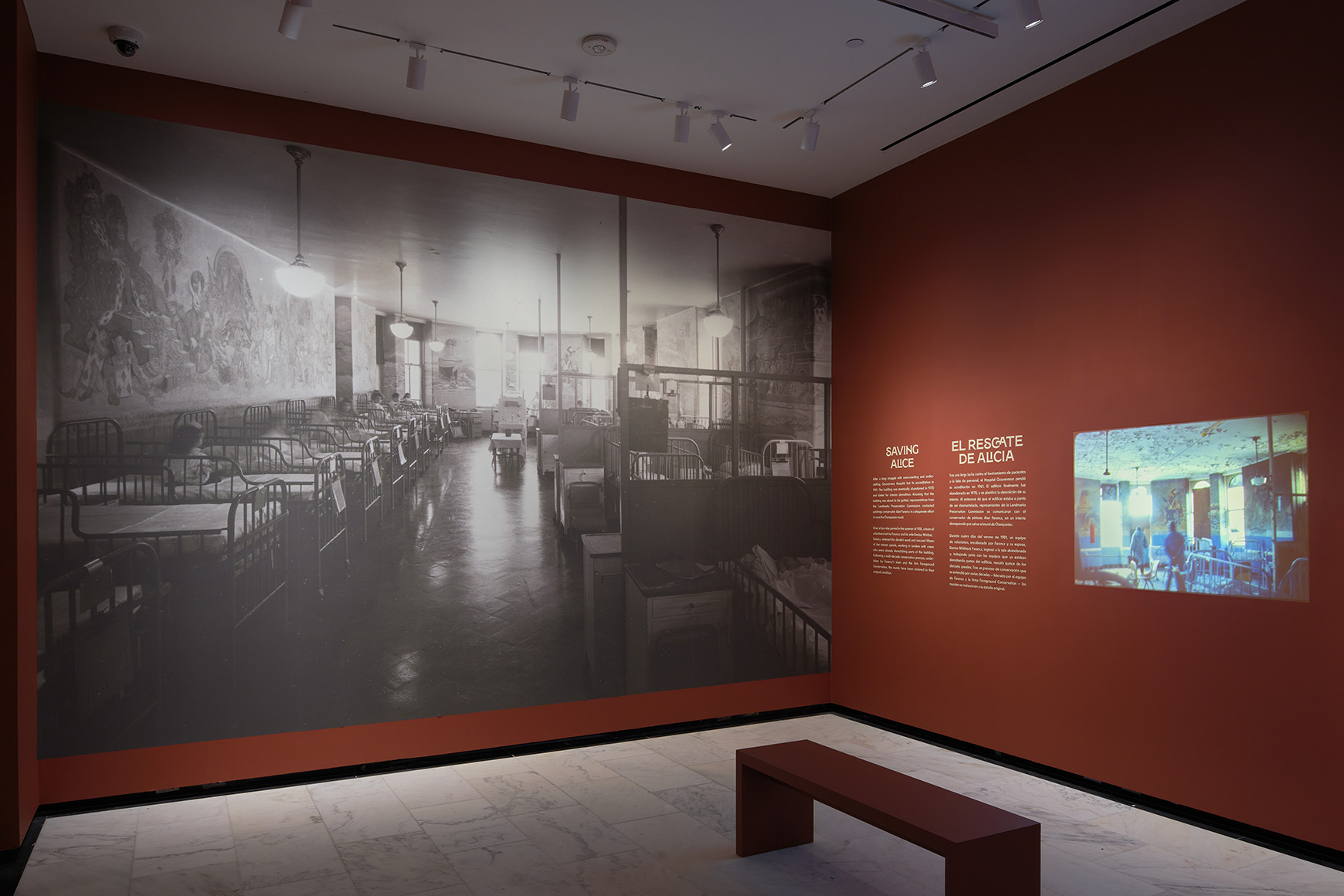 A large reproduction of a black and white photograph of a hospital interior, next to a projected video.