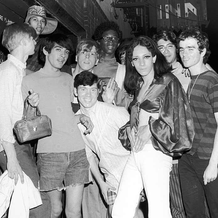 LGBTQ バーの若い常連客のグループの白黒写真。