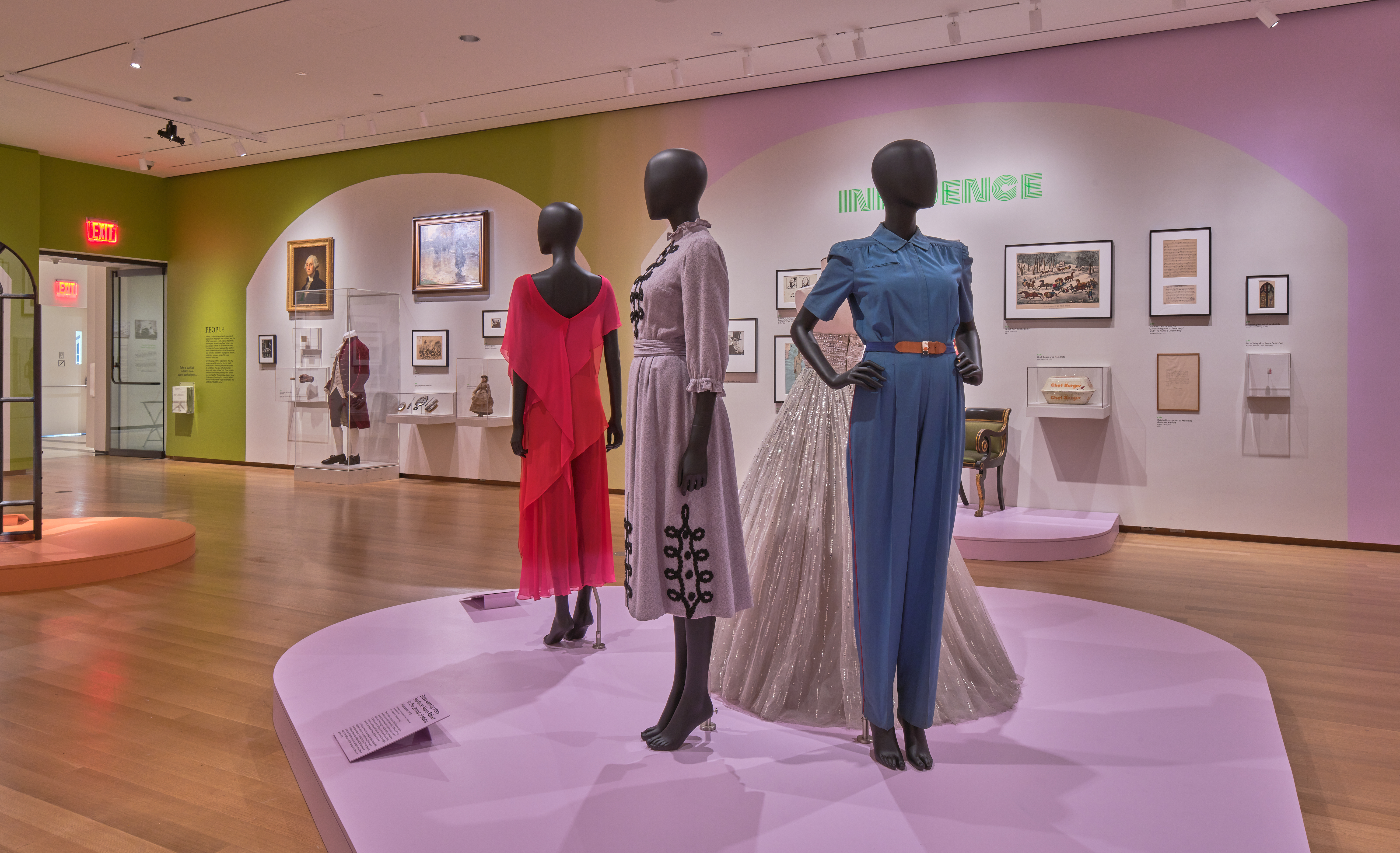 Three mannequins are displayed in a gallery.