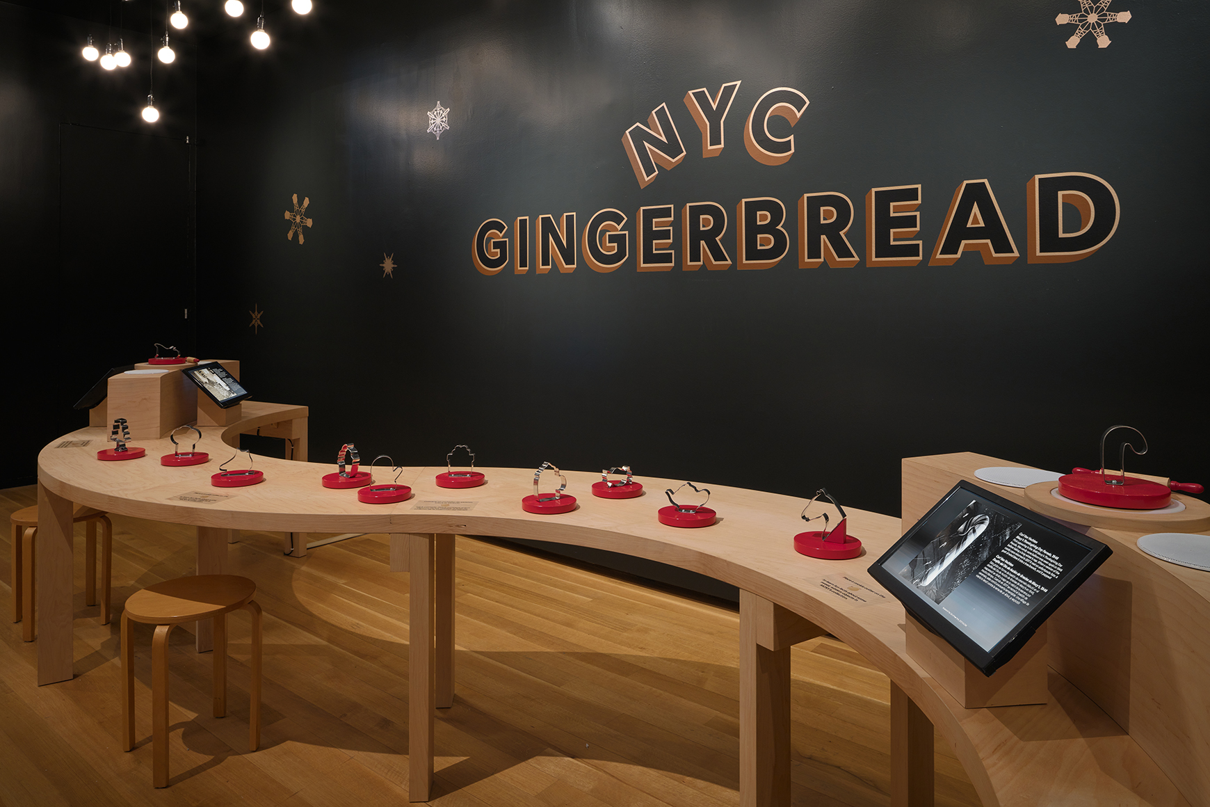 A wavy wooden table in front of a sign reading, "Gingerbread NYC"