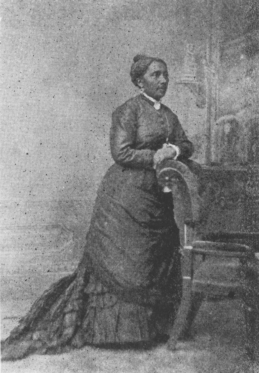 A sketch drawing of a woman in a 19th century dress leans against a chair. 