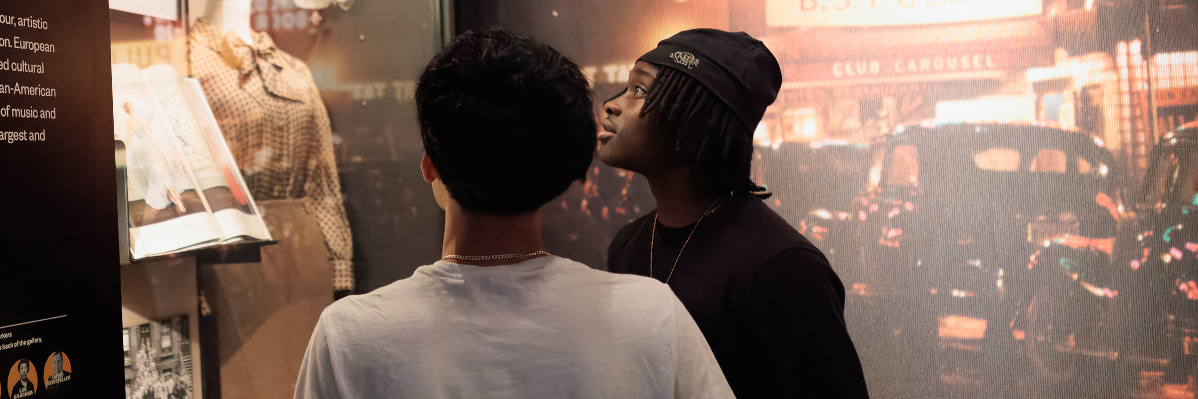 Two students look at objects in an exhibition.