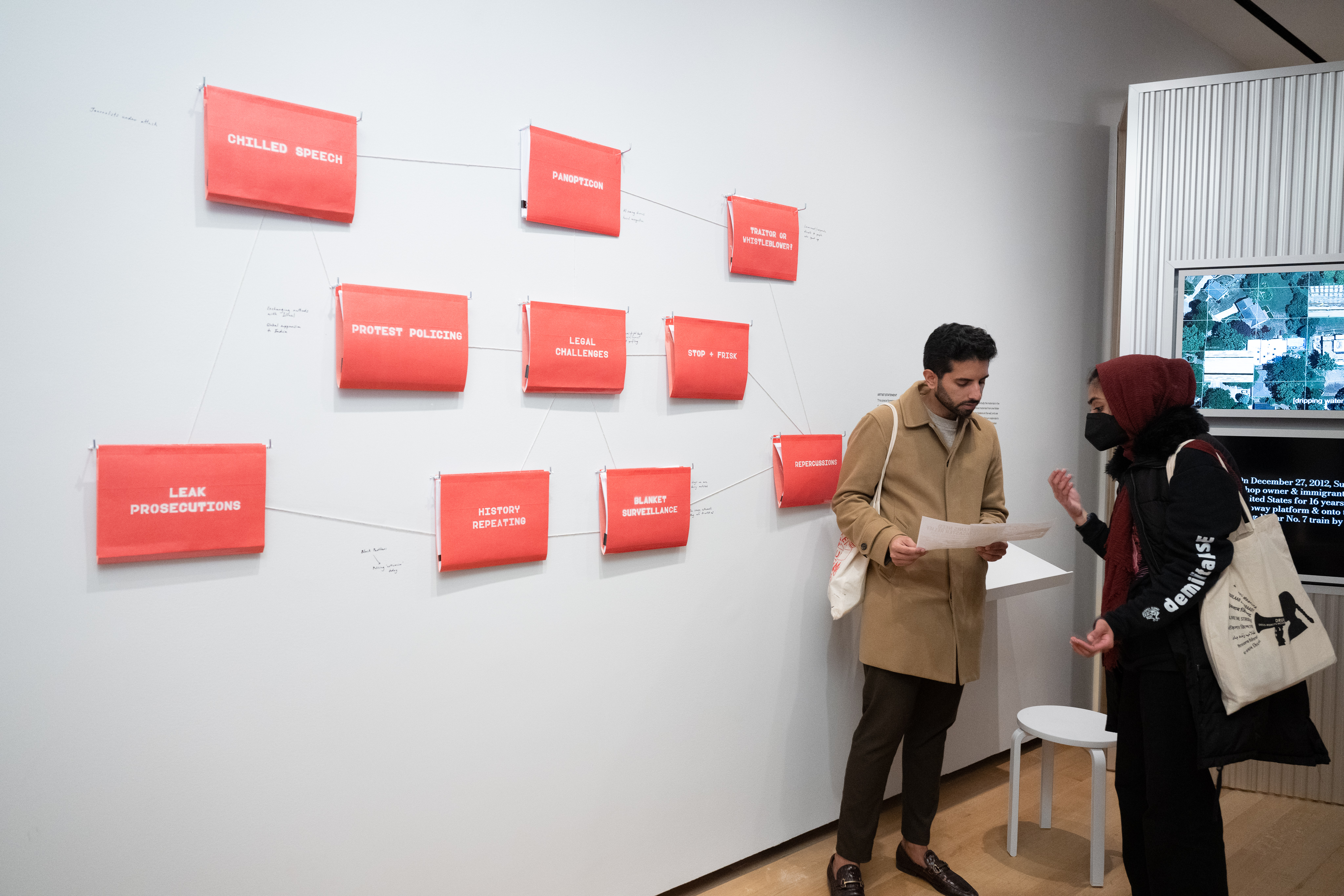 Visitors interact with artists Chitra Ganesh and Mariam Ghani’s installation “Index of the Disappeared.” 