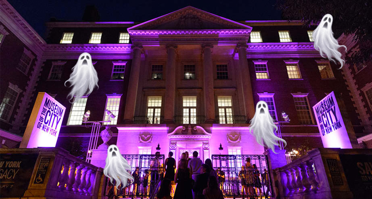 The facade of the Museum illuminated by purple lights, with Halloween ghosts flying above