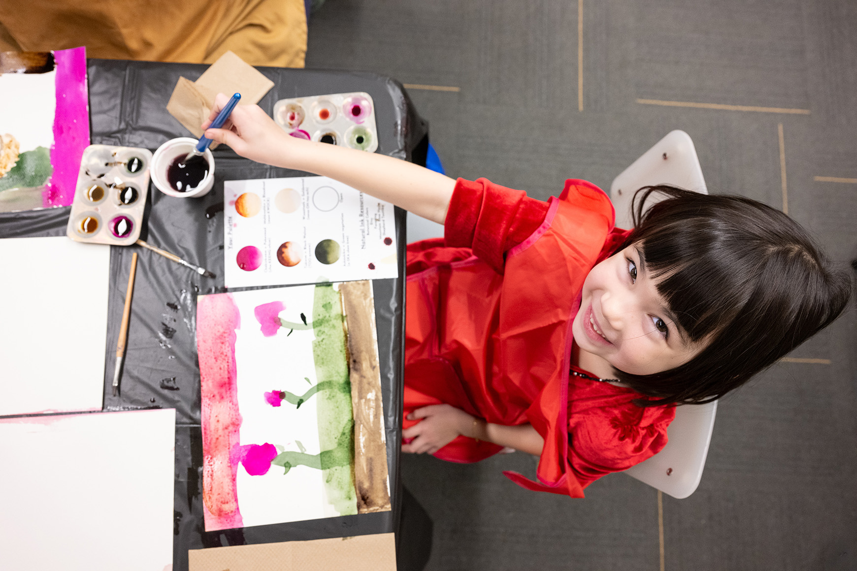 One child creating an artwork with watercolor paint.
