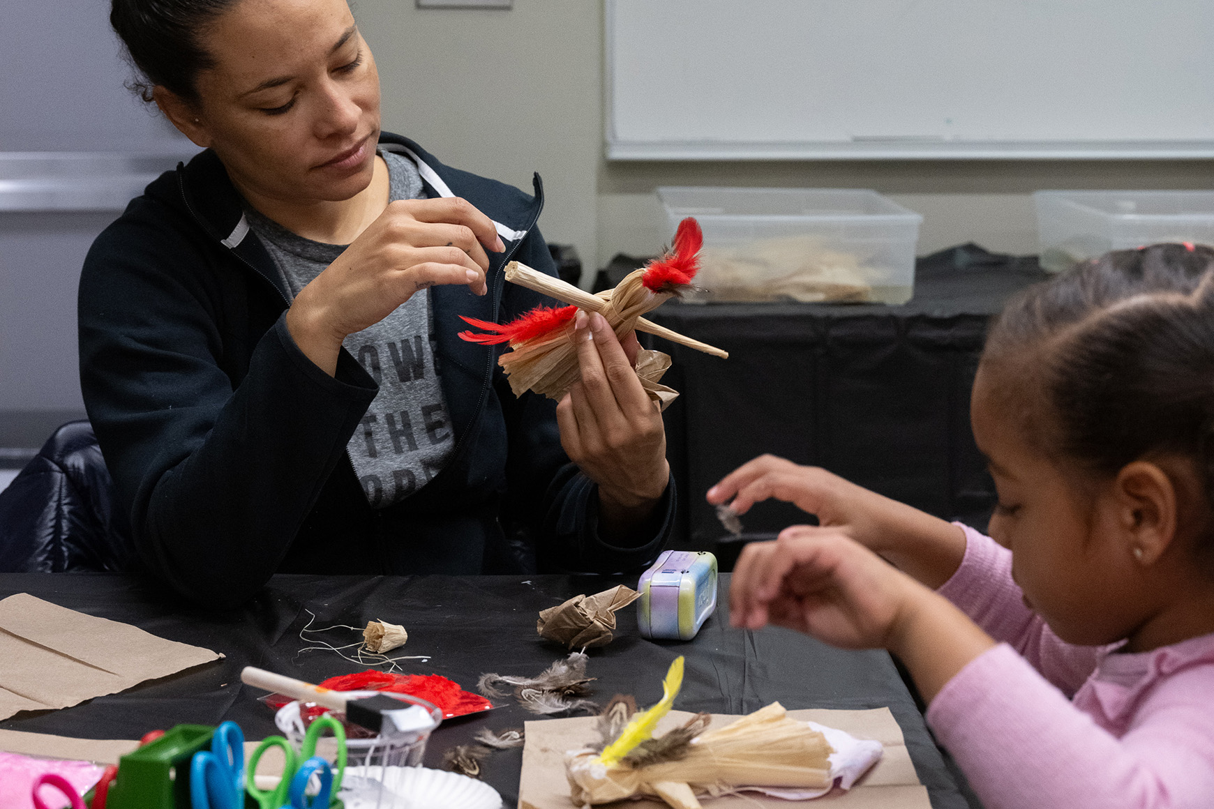 An adult and a child creating an artwork together.