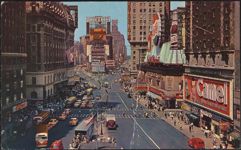 Wide view looking down the street of Times Square.