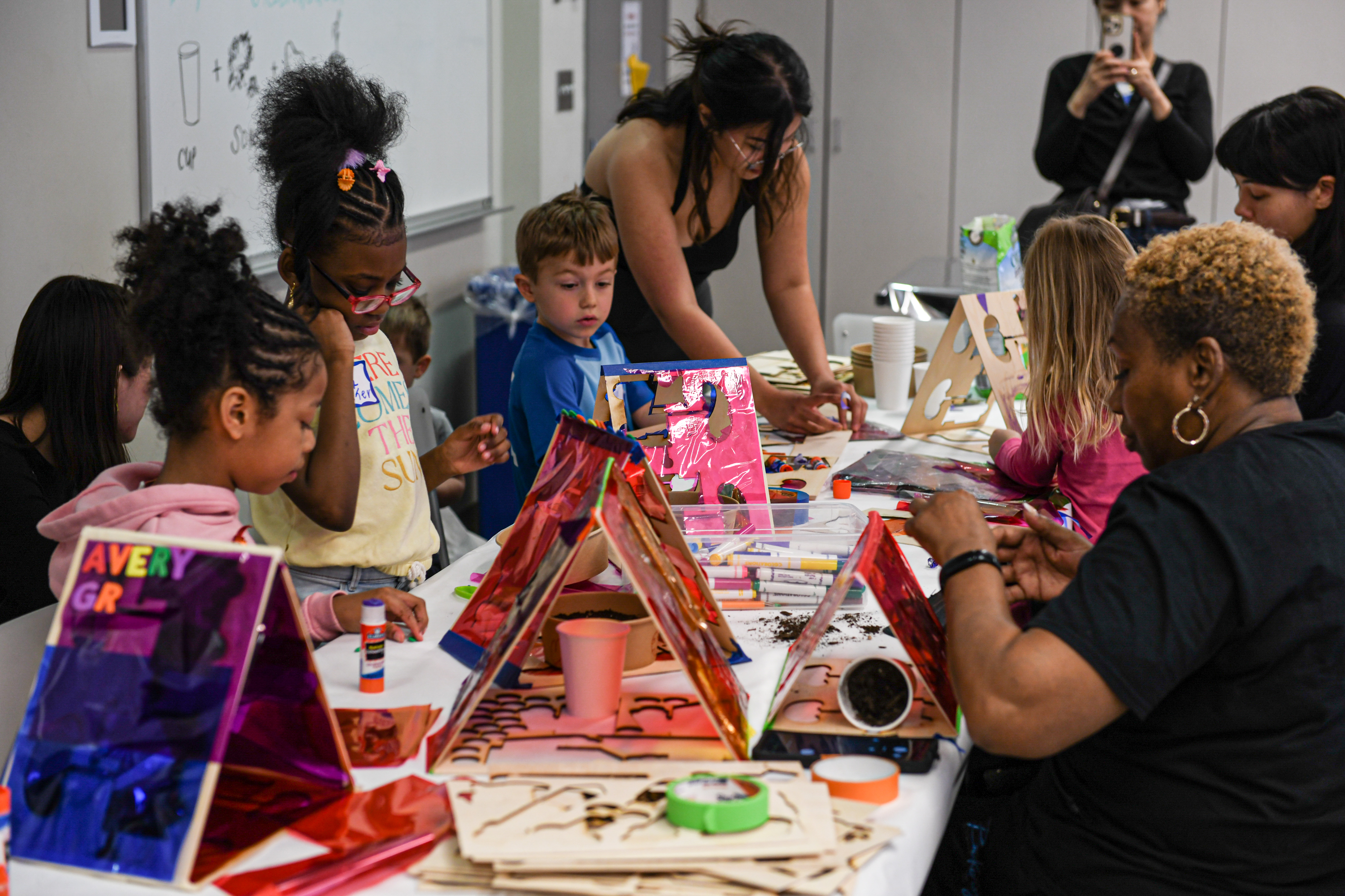 Kids making art at a table.