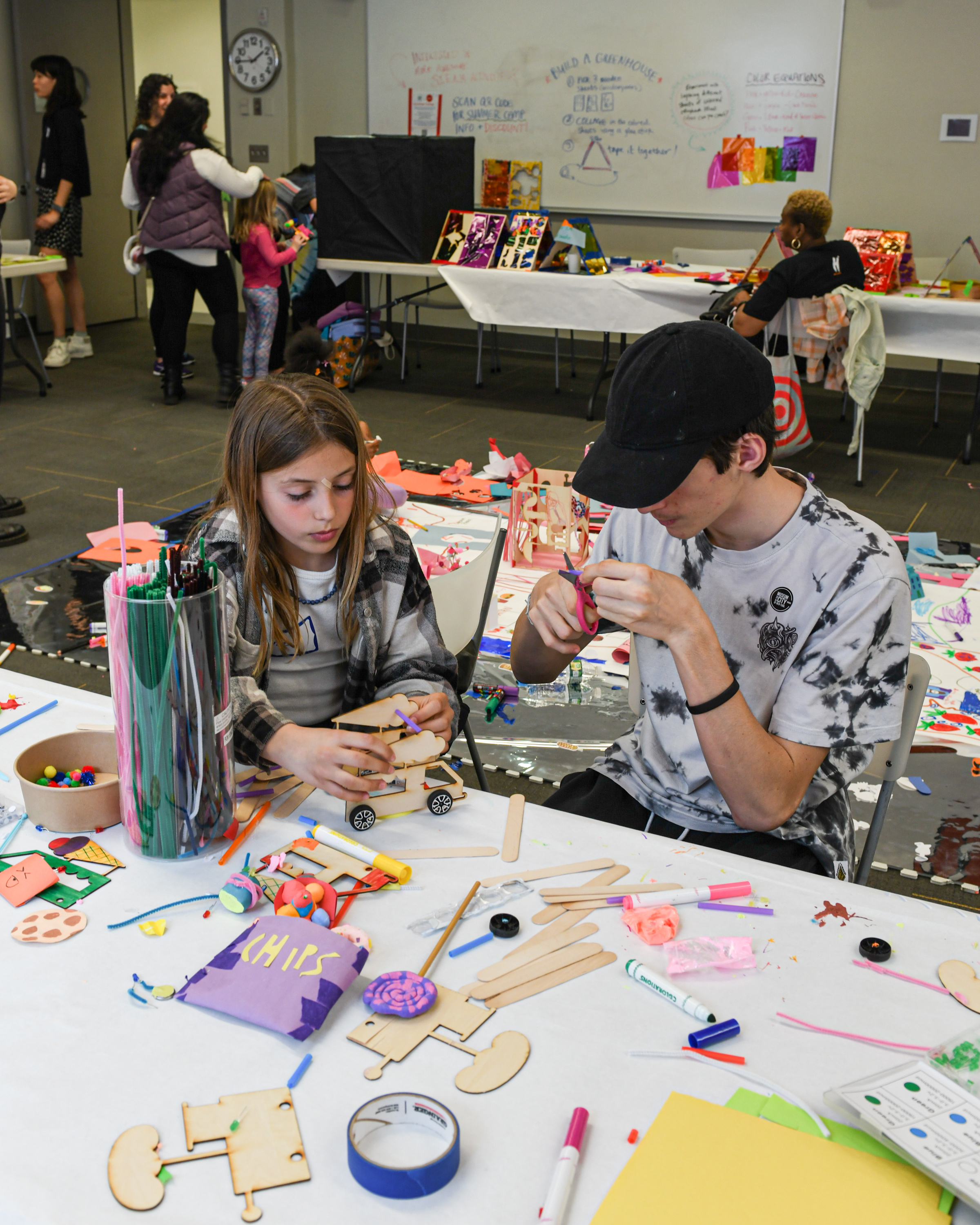 Two children work on an art project.