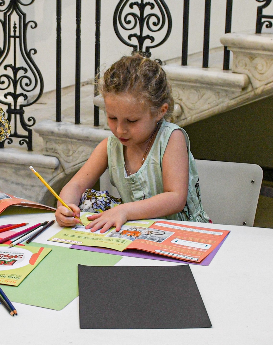 A child writes in a booklet. 