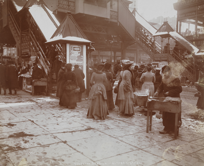 Crowds of people at the entrance staircases to the Sixth Avenue elevated train at Twenty-third Street.