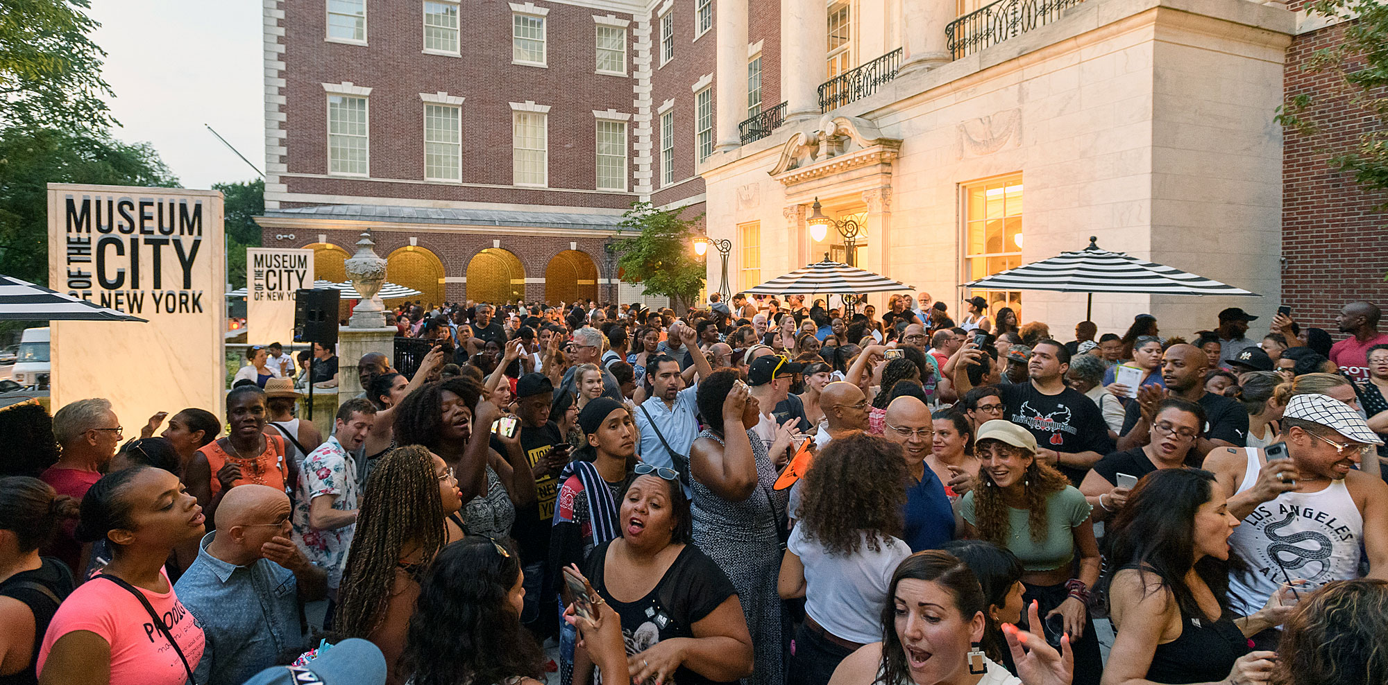 People attending a summer outside party at the Museum of the City of New York