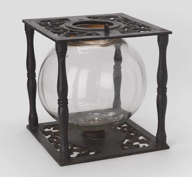 Ballot box with glass globe in cast iron frame.