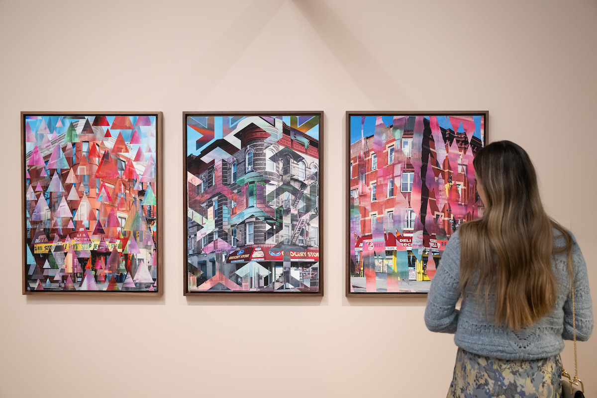 A woman, right, looks at the selection of Anders Jones photographs in "New York Now: Home." 