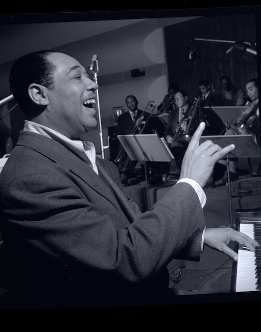 Photograph of Duke Ellington leading a performance.