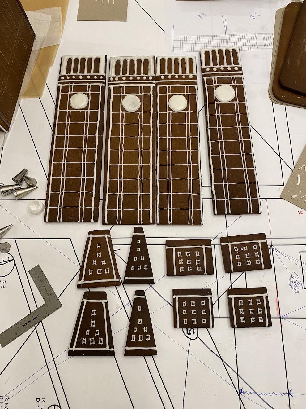 Elements of a gingerbread display showing the individual pieces of the clock tower in Madison Square Park.
