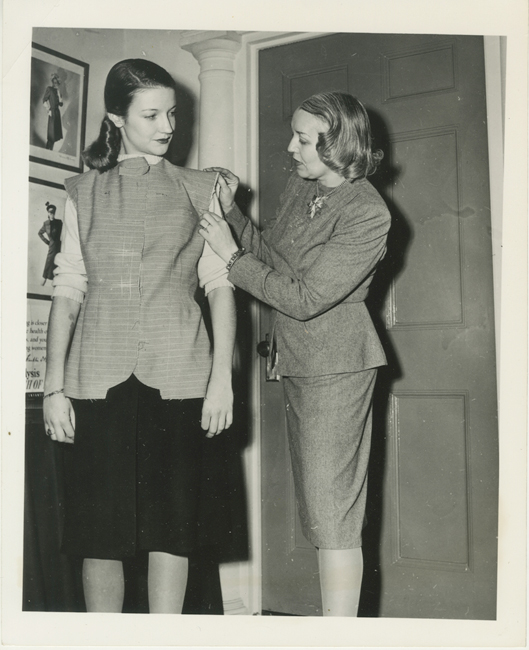 A photo of Vera Maxwell fitting a model for Museum of the City of New work's "A Salute to Vera Maxwell" back in 1942. 