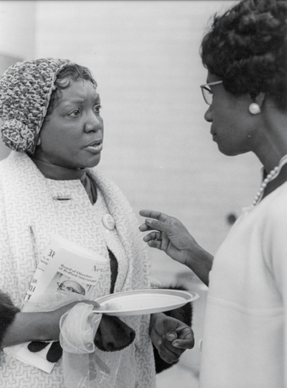 Two women talk to each other. 