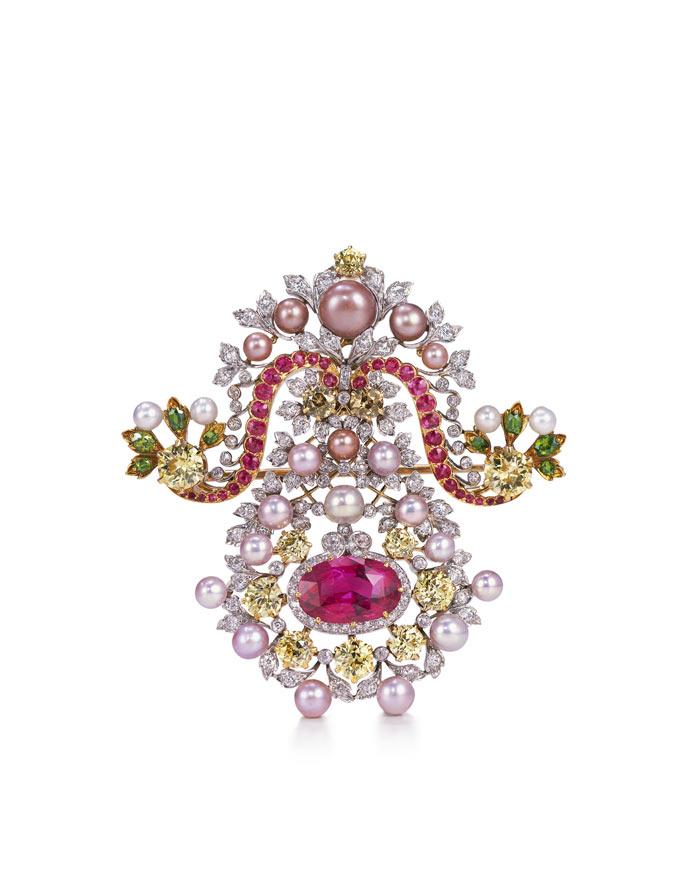 Brooch made of a metal backing with pink, yellow, and green diamonds, pink and white pearls, and silver leaves
