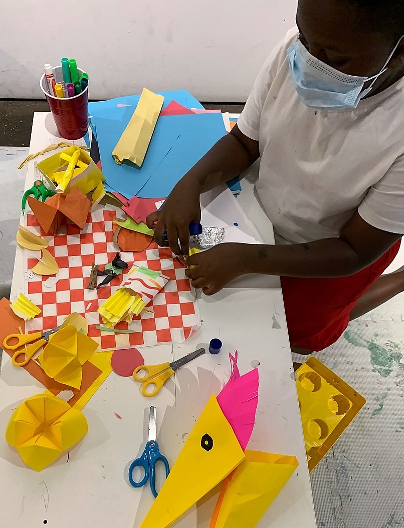 A child makes a paper artwork.