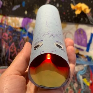 A decorative tube with googly eyes.