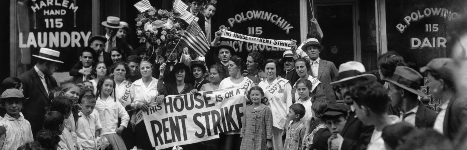 A group of men, women, and children during a rent strike in Harlem. 