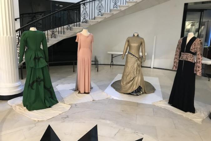 Quatre robes ayant appartenu à Marian Anderson, de couleurs et de styles variés, habillées sur des mannequins placés devant l'escalier principal du Musée.