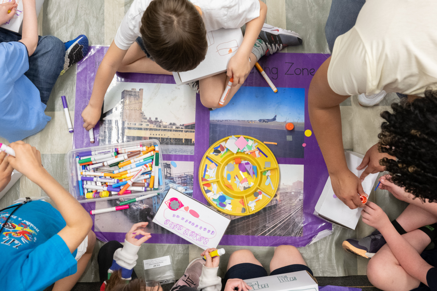 A group of students participating in an art making activity. 