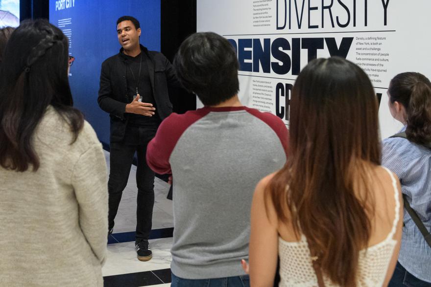 A tour guide leading a group through New York at Its Core