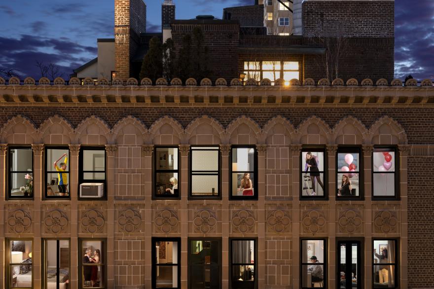 Neighbors seen through apartment building windows
