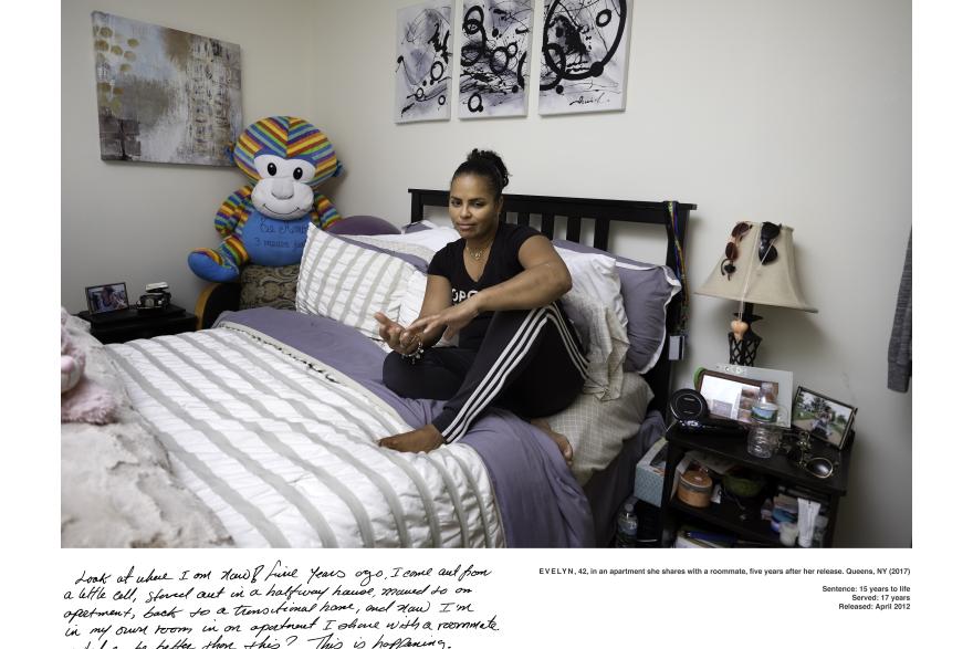 Woman poses for photograph sitting on her bed