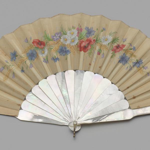 A museum photo of a folding fan of painted chicken skin between 1886-1889.