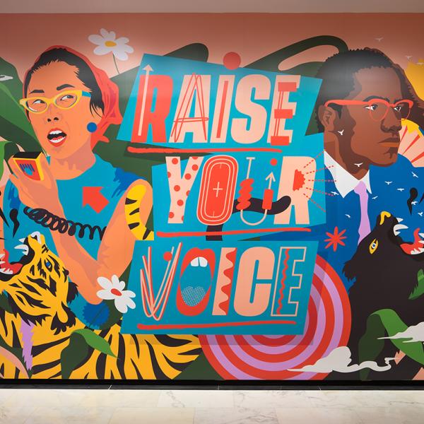 Photograph of the immersive installation "Raise Your Voice," original artwork of activists and allies Yuri Kochiyama and Malcolm X by artist Amanda Phingbodhipakkiya.