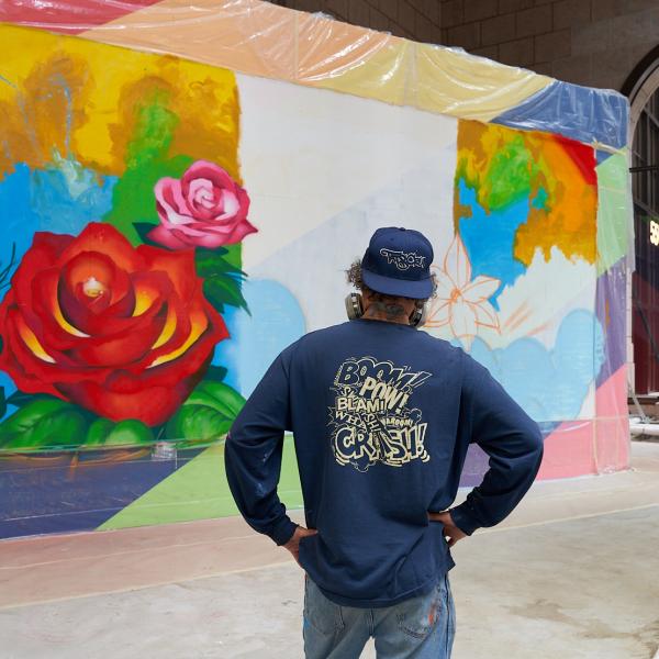 Christopher "Daze" Ellis looking at a painting he is creating at 550 Madison 