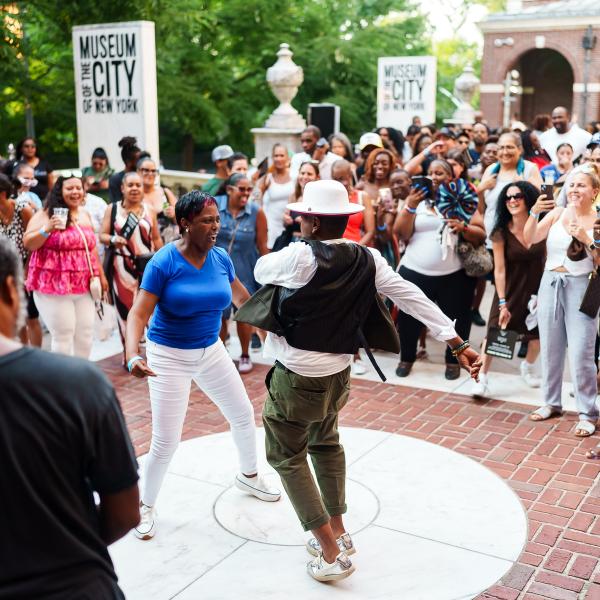 Two people dancing on the front terrace of the Museum of the City of New York