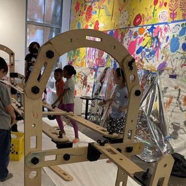 A child works on a constructed toy. 