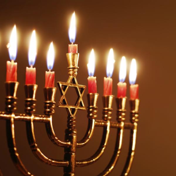 A Hanukkah menorah with all candles lit.