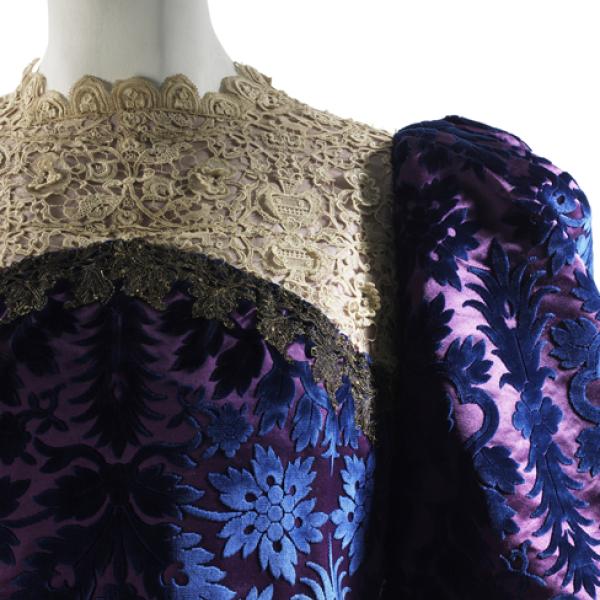 Family garment from the house of Worth. This garment is a tea gown of cut and voided velvet trimmed with lace