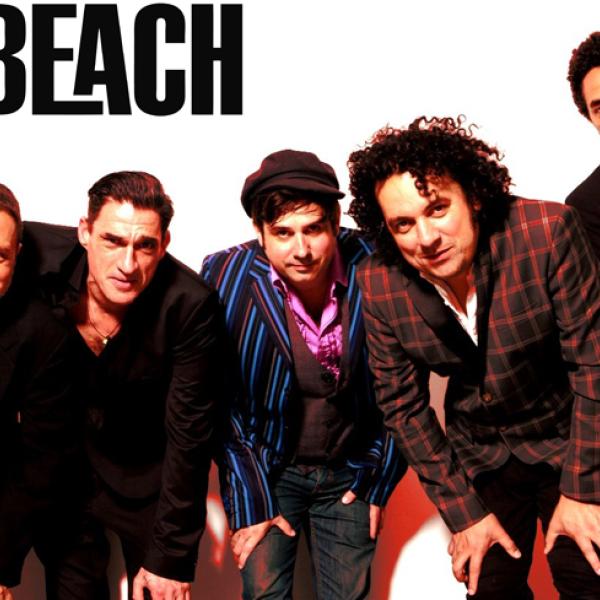 The five members of Locobeach are standing in a line. They are slightly hunched over looking at the camera positioned on a lower angle. 