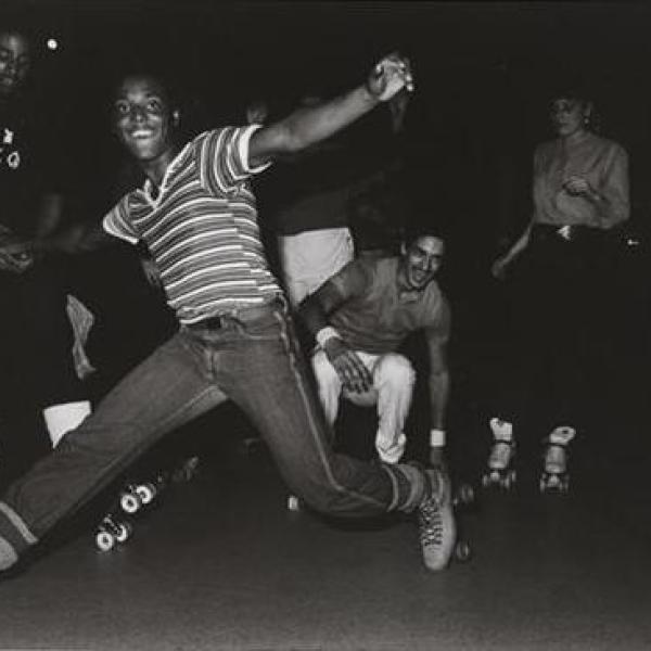 Photograph of a boy in roller skates.