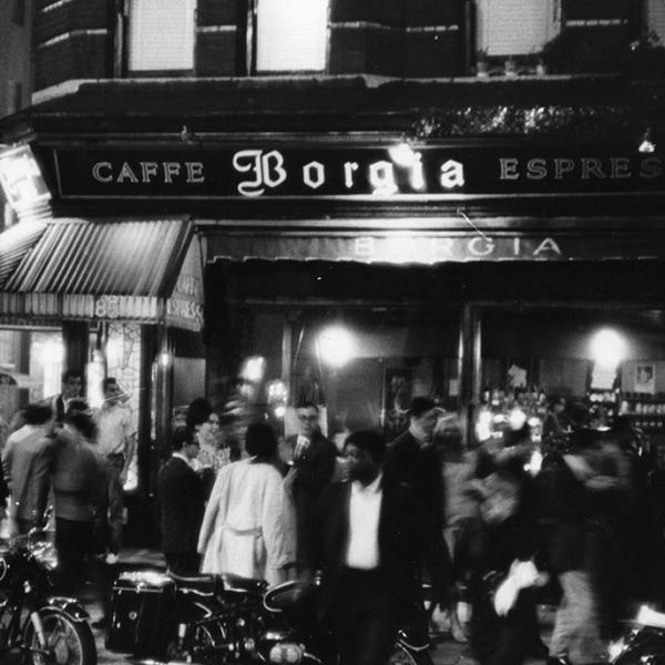 Photograph by Fred W. McDarrah of a motion-filled crowd outside the Caffe Borgia in Greenwich Village