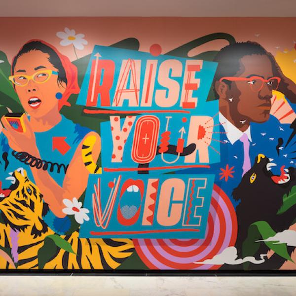 Photograph of the immersive installation "Raise Your Voice," original artwork of activists and allies Yuri Kochiyama and Malcolm X by artist Amanda Phingbodhipakkiya.