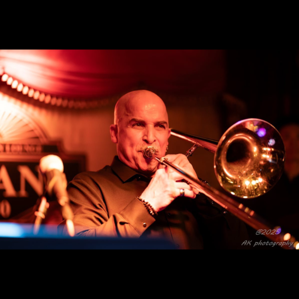 Headshot of Musician Jimmy Bosch Playing Trombone