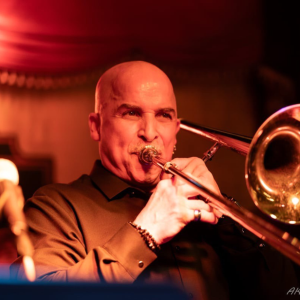 Headshot of Musician Jimmy Bosch Playing Trombone
