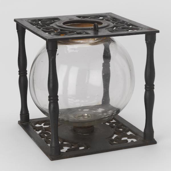 Ballot box with glass globe in cast iron frame.